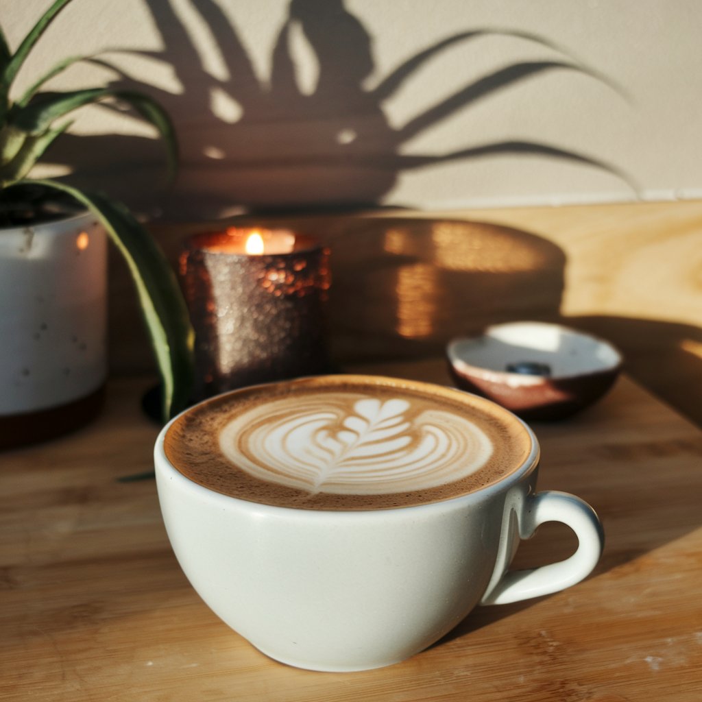 Professional barista latte art in cozy cafe setting